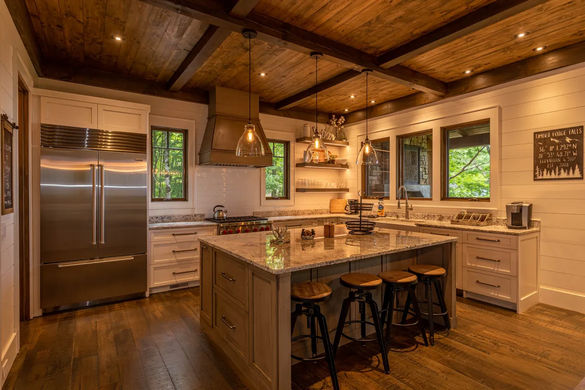 A warm, inviting kitchen is anchored by a substantial granite island, accented with stylish hanging lights and surrounded by barstool seating. Top-tier stainless steel appliances, including a Sub-Zero/Wolf setup, and exposed wooden beams overhead emphasize the gourmet quality and rustic charm of the space. Family members can be imagined chatting, cooking, or sharing a quick snack at the island.